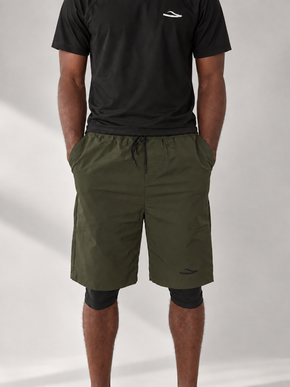 Visuel illustratif KAESSAR : short olive et T-shirt de bain noir sur mannequin à peau foncée, montage IA